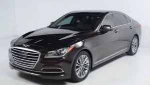 A deep bronze-colored Genesis G80 sedan in a bright studio environment.